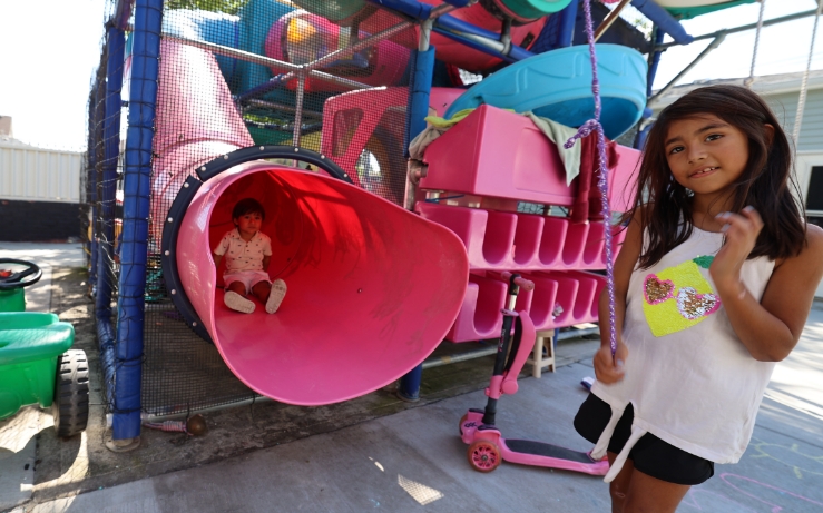 Children standing in front of playground outside