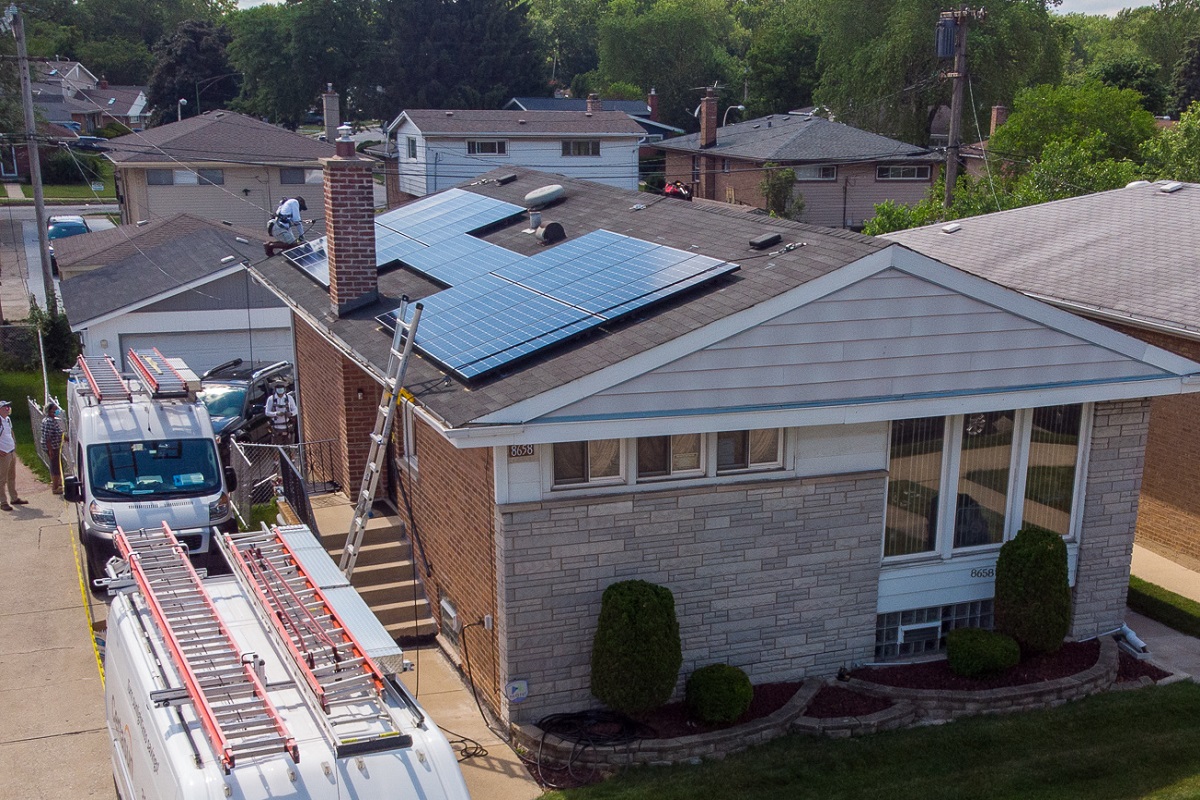 Construction of solar panels going on the roof of a single family home