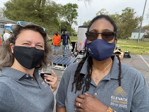 Two women wearing masks taking a selfie