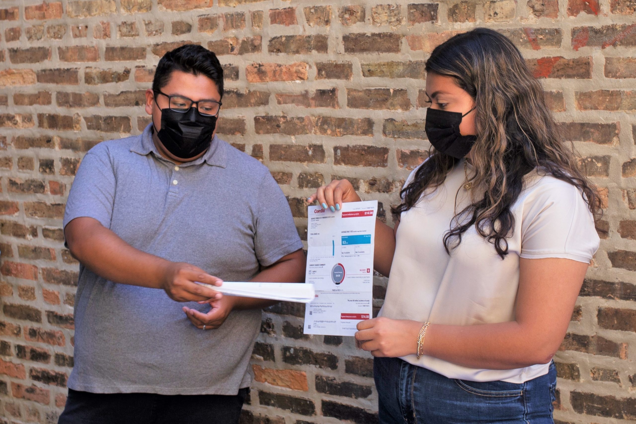 Jose Hernandez, Cynthia Segura showing energy bill