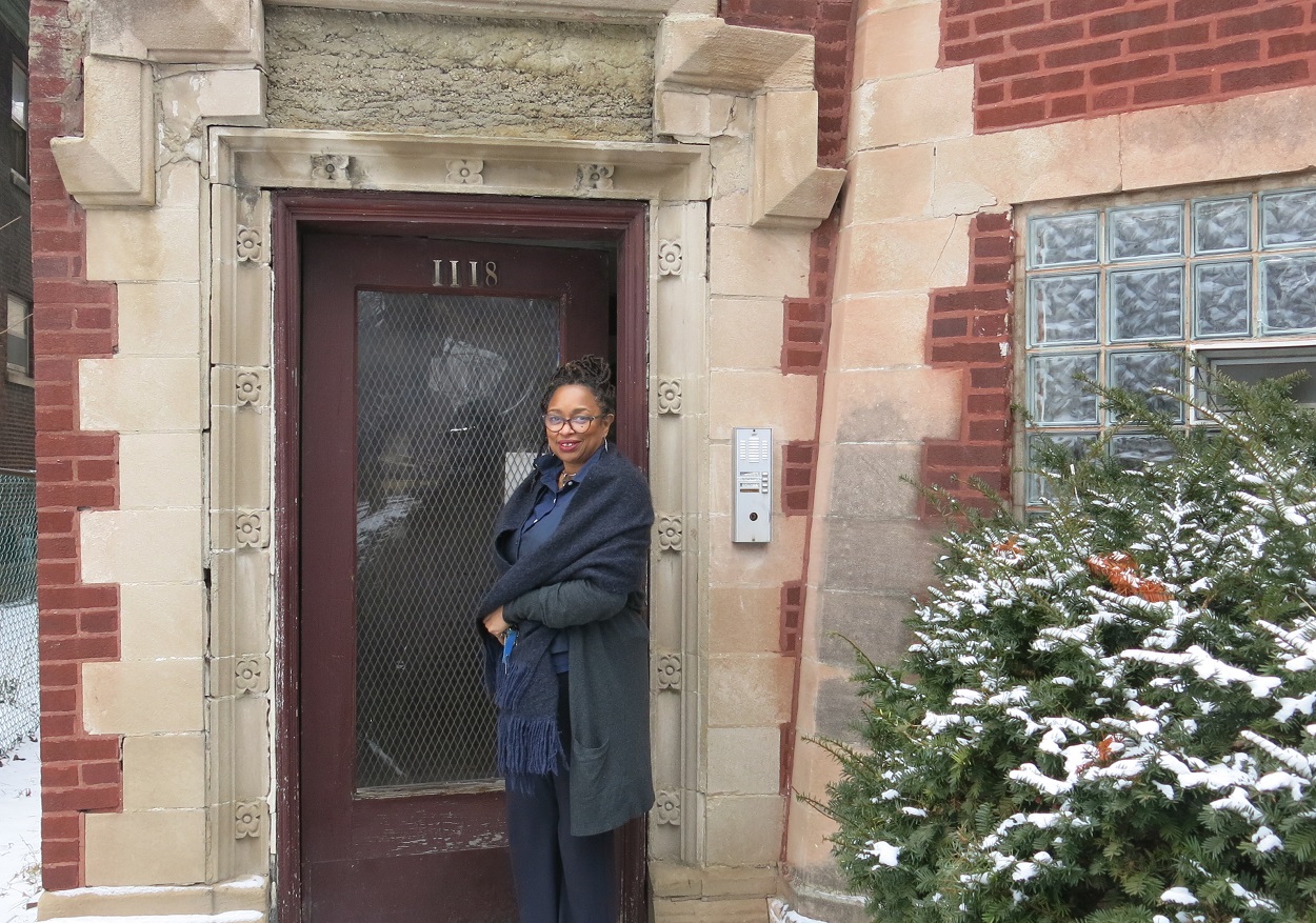 woman standing in front of multifamily building