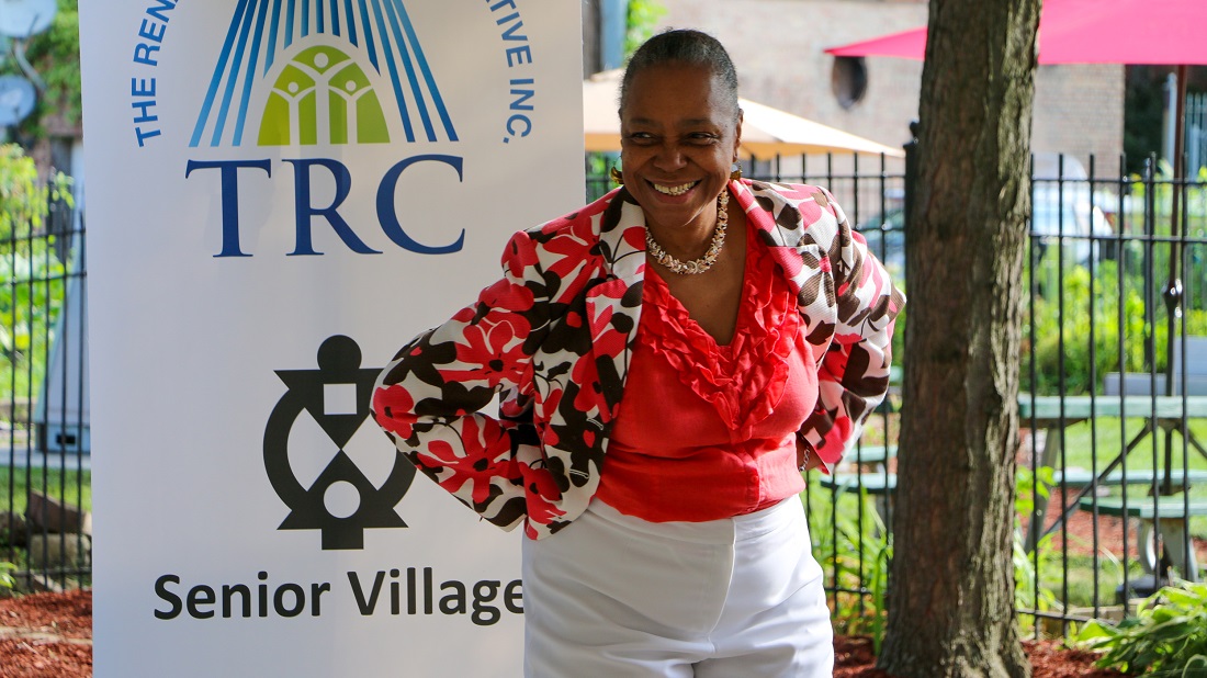 Woman standing outdoors smiling