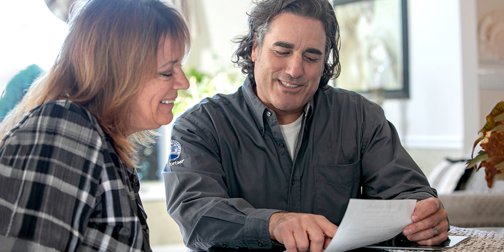 two people looking over paperwork 
