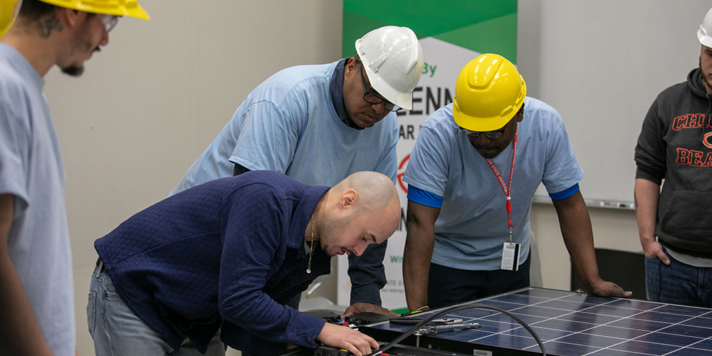 Trainees working on a solar project 
