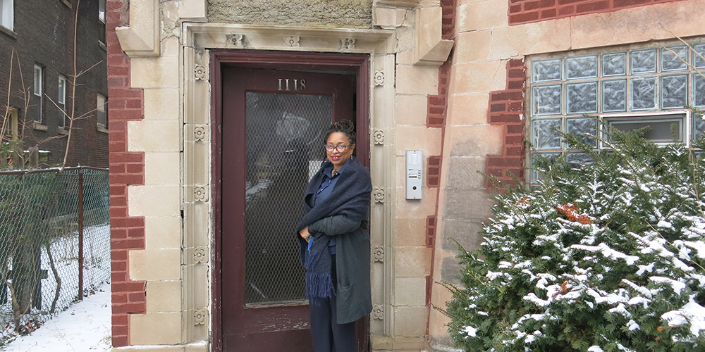 woman standing outside front door of hom 