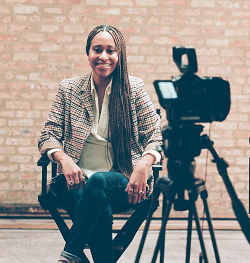 A woman sitting in a director's chair