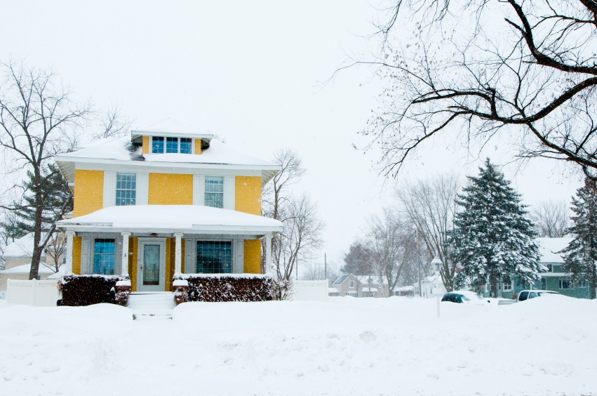 Single family home covered in snow