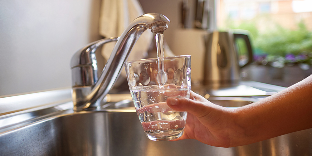 glass of tap water being filled 