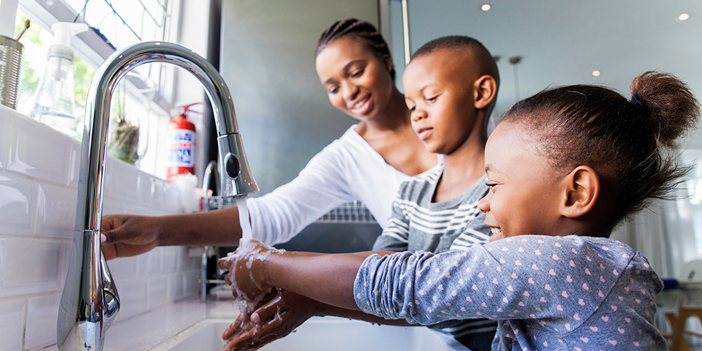 mother and children washing hands 
